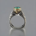 Gold-plated flower-shaped ring with vintage gemstone details in green silver colour