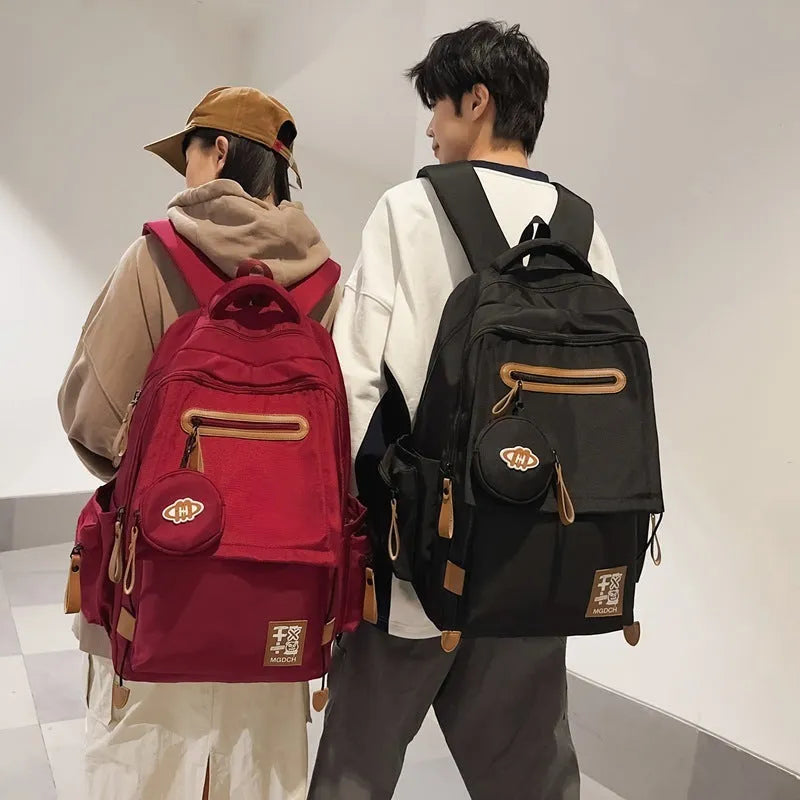 Large black nylon backpack with curved shoulder straps for middle school students