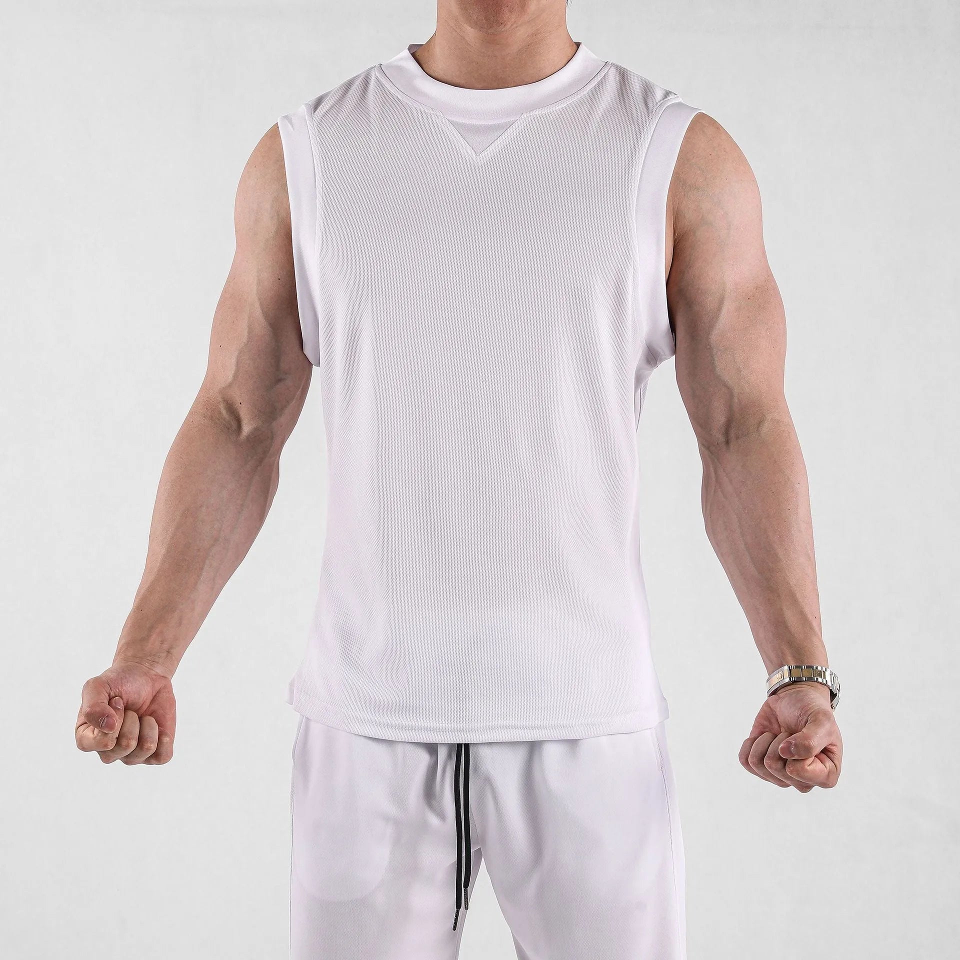 Men's loose fit sports vest in black or white made from breathable quick-dry chemical fibre blend for summer gym training