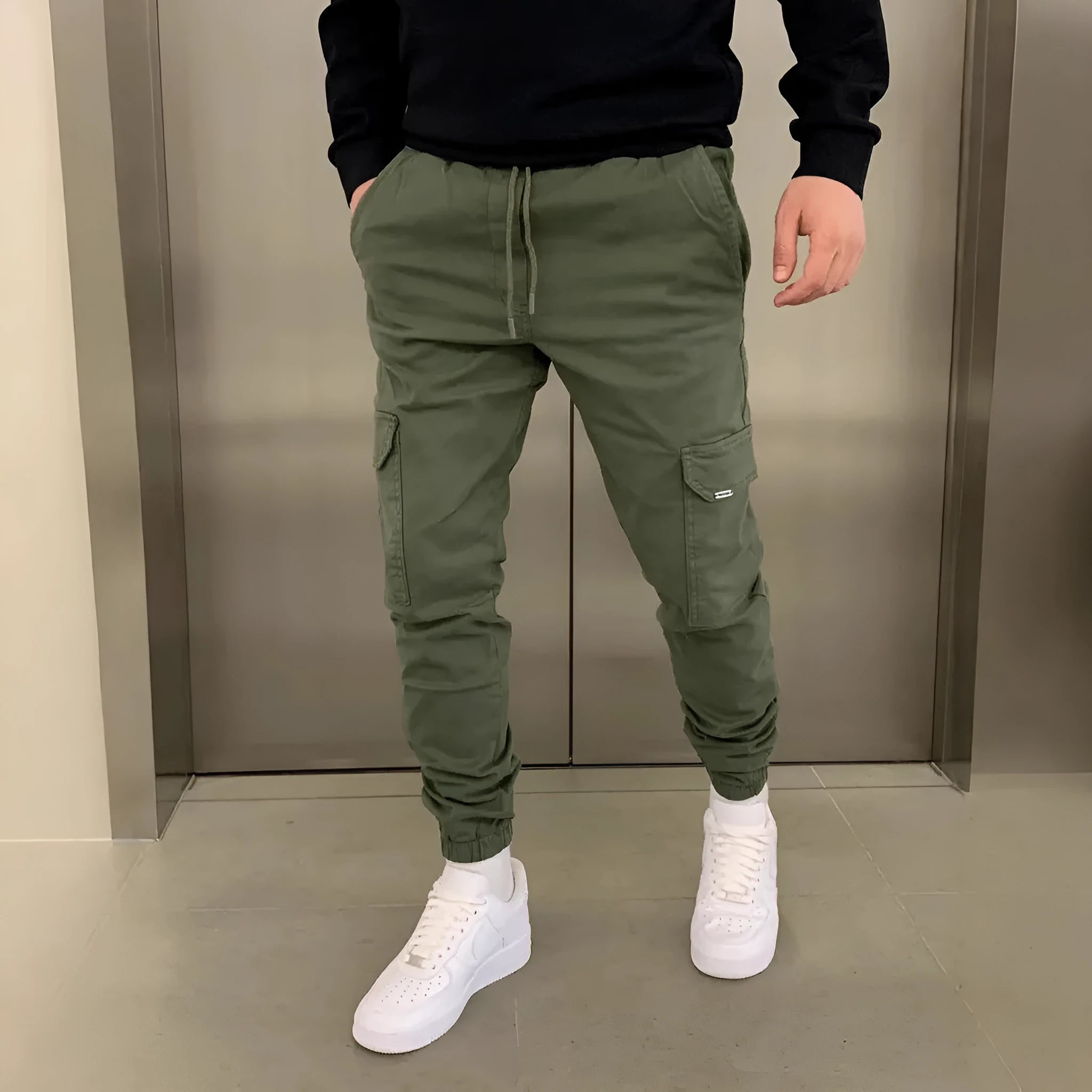 Men's loose polyester trousers with patch pockets and elastic waistband in light blue colour