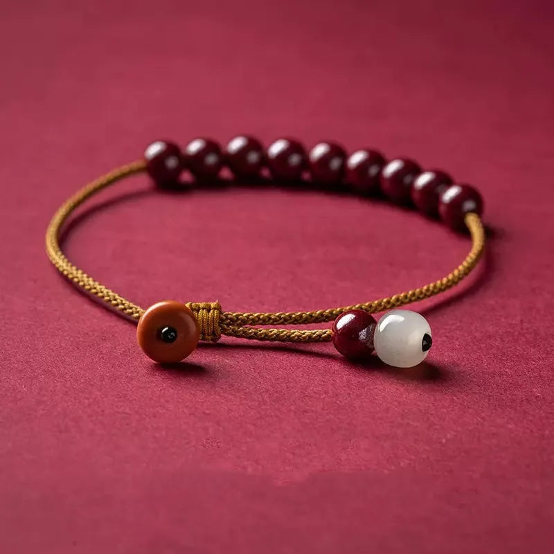Hand-woven raw ore cinnabar bracelet with Hetian jade accents in a geometric design.