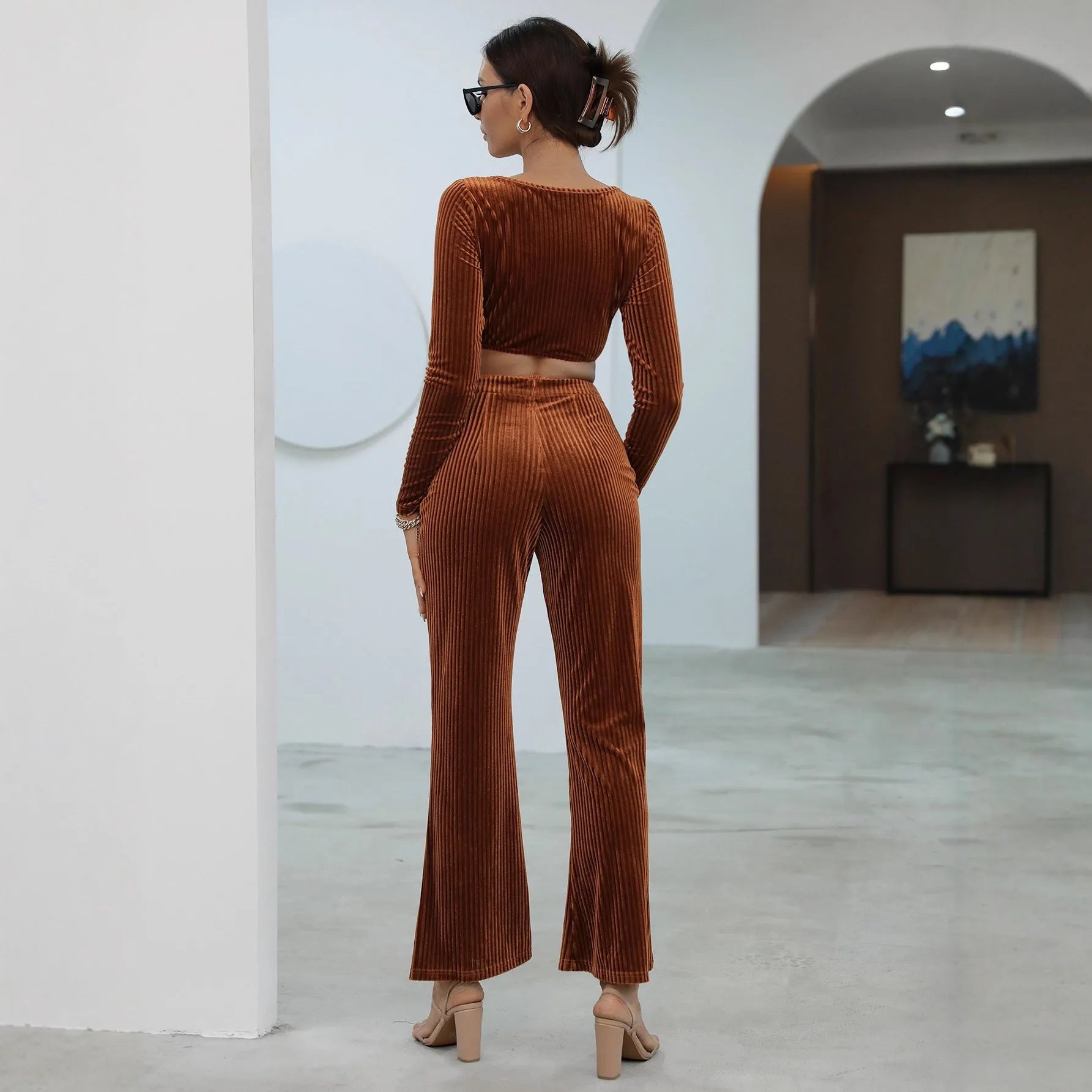 Caramel coloured women's long sleeve sweater and jogger lounge set laid flat.