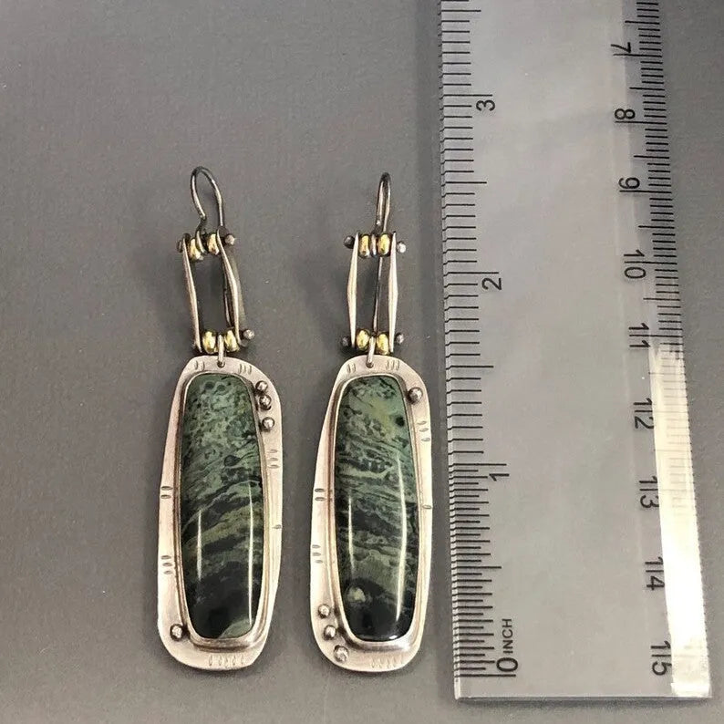 Geometric alloy earrings with black and white marble pattern showing front and side views