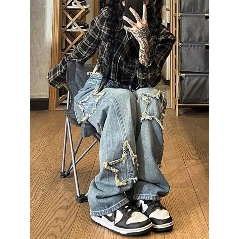 Blue high-waisted wide-leg denim trousers on a hanger, showing the straight-leg cut and front view.