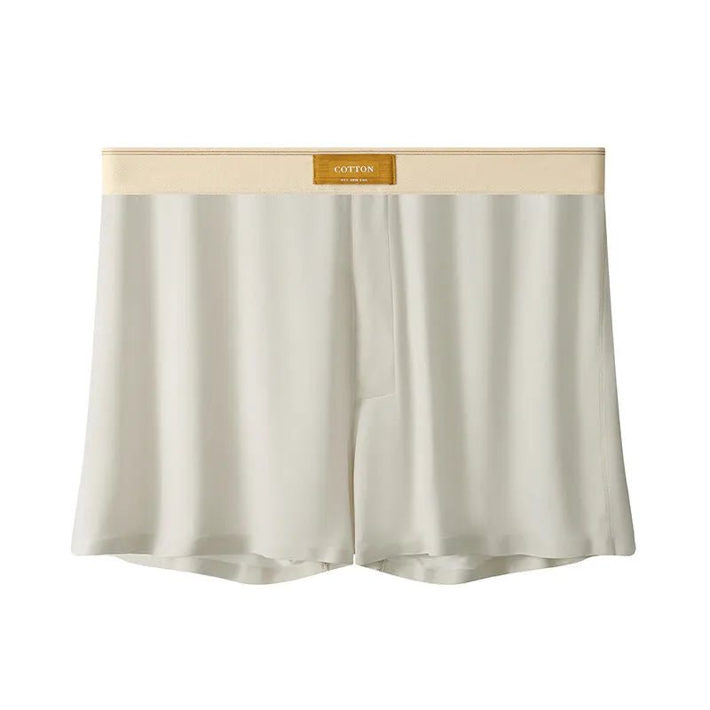 Pack of three men's solid colour loose fit ice silk underwear briefs on a grey background.