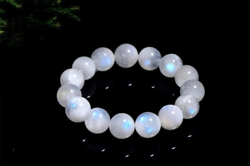 Natural blue moonlight round moonstone bead bracelet on wrist showing polished surface