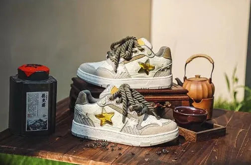 Green low-top casual trainers with star pattern stitching and a white rubber sole.