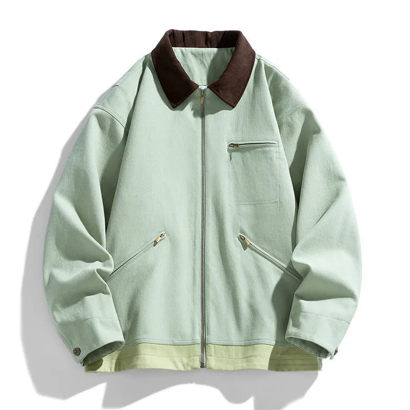 Man wearing a mint green retro workwear jacket with dark contrast lapels and side pockets.