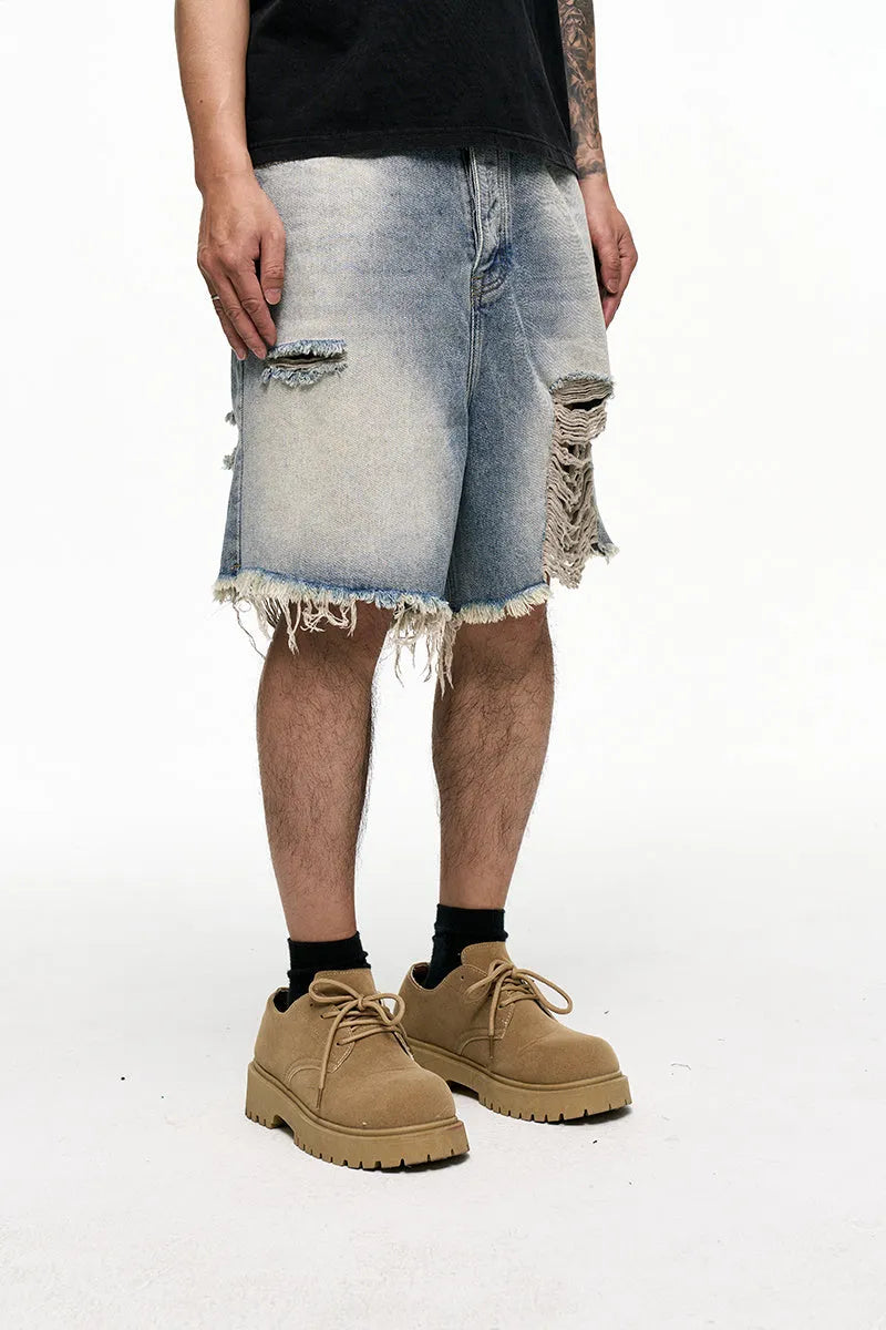 Light blue men's baggy denim shorts with wide leg and mid waist on a plain background