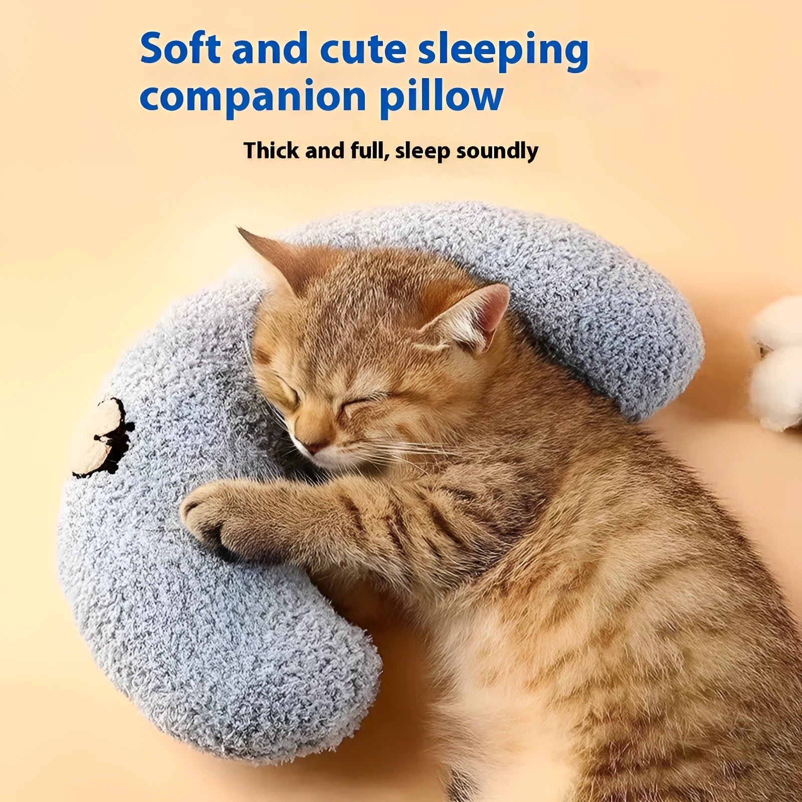 Blue U-shaped cat sleeping mat with moon design next to a yellow question mark shaped pet pillow.