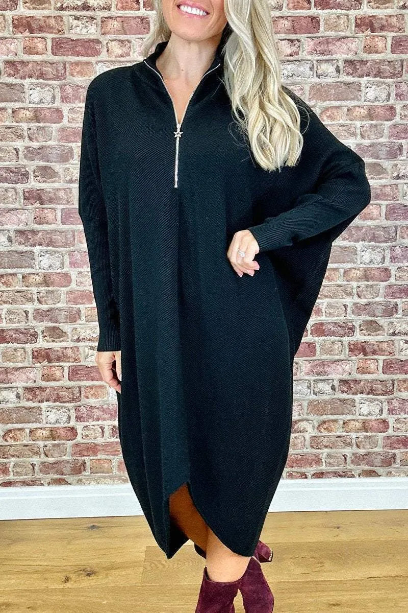 Women's solid colour loose fit knitted dress with raglan sleeves on a model.