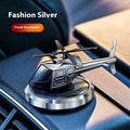 Silver metal solar-powered rotating helicopter car perfume ornament on dashboard