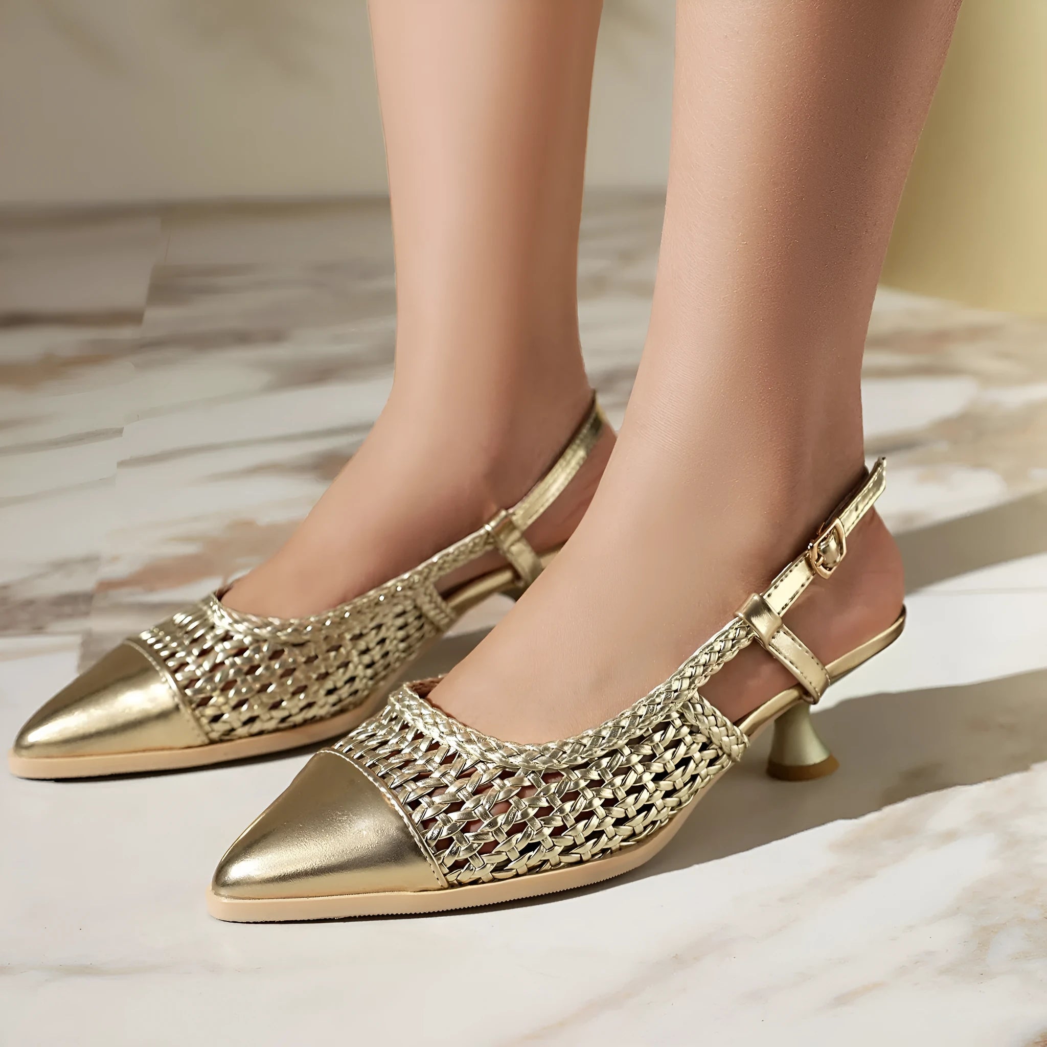 Black women's cat heel sandals with hollow-out design and buckle closure on a white background.