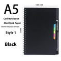 Erasable coil-bound notebook with customisable coloured cover on thick, reusable rock paper, shown with a pen.