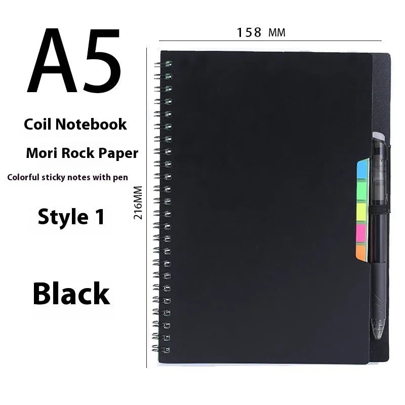Erasable coil-bound notebook with customisable coloured cover on thick, reusable rock paper, shown with a pen.