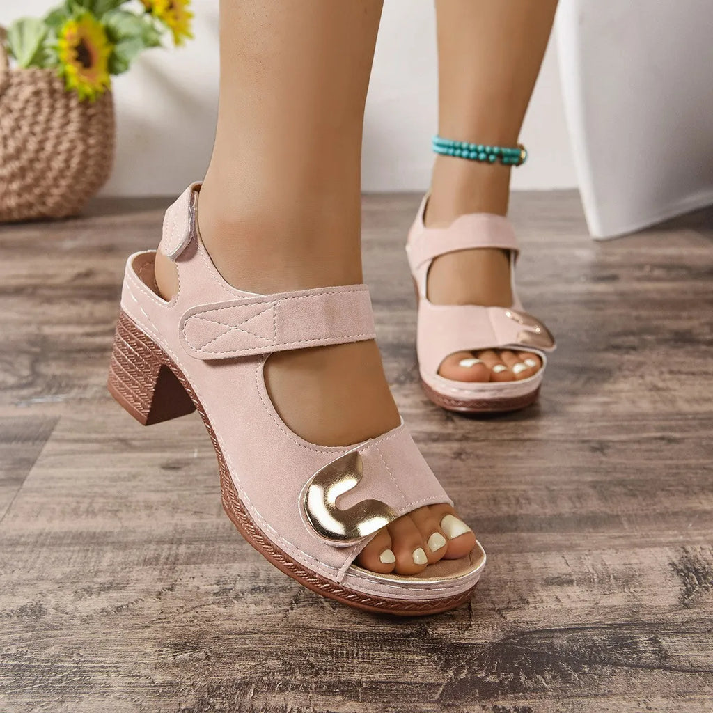 Women's light brown flat Roman sandals with a Velcro strap fastening and round toe.