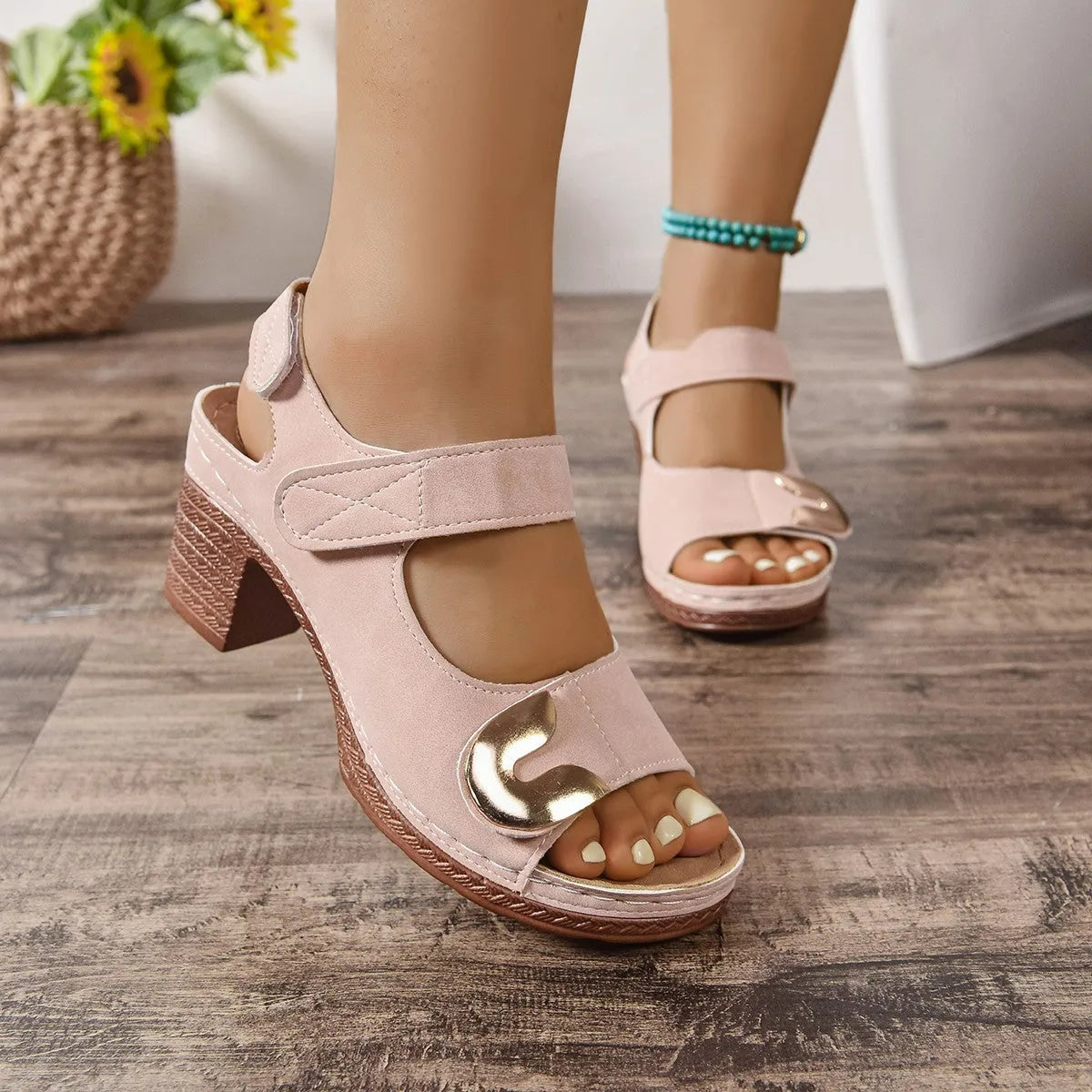Women's light brown flat Roman sandals with a Velcro strap fastening and round toe.