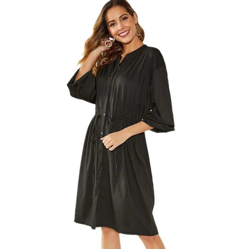 Black A-line dress with elastic waistband and cuffs, mid-length design for professional wear