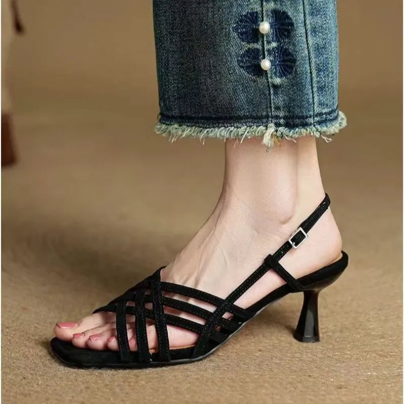 Light brown retro women's sandals with thin cross straps, ankle buckle, square toe, and a mid heel.