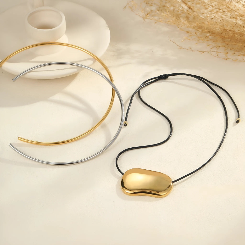 Stainless steel geometric pendant necklace on a black rope-style chain with an adjustable 41-50cm length.