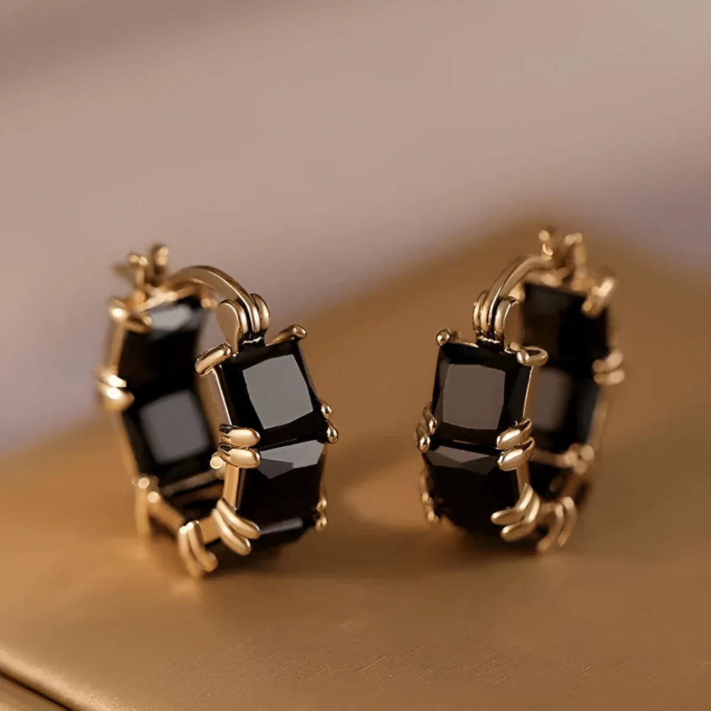 Gold geometric U-shaped women's earrings with a round black zircon stone.