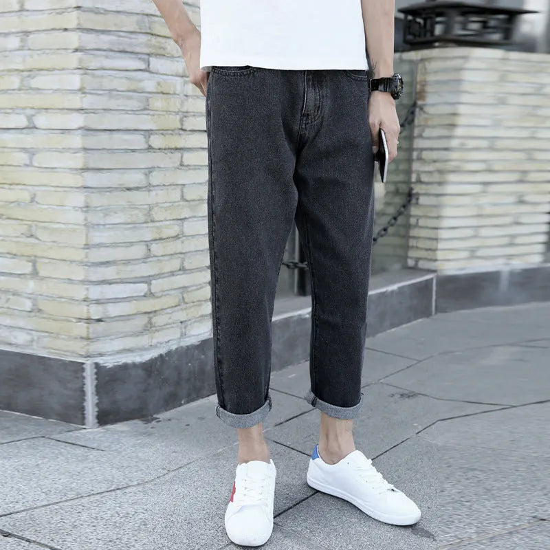 Men's loose straight leg harem jeans in black cotton denim with light straight leg opening