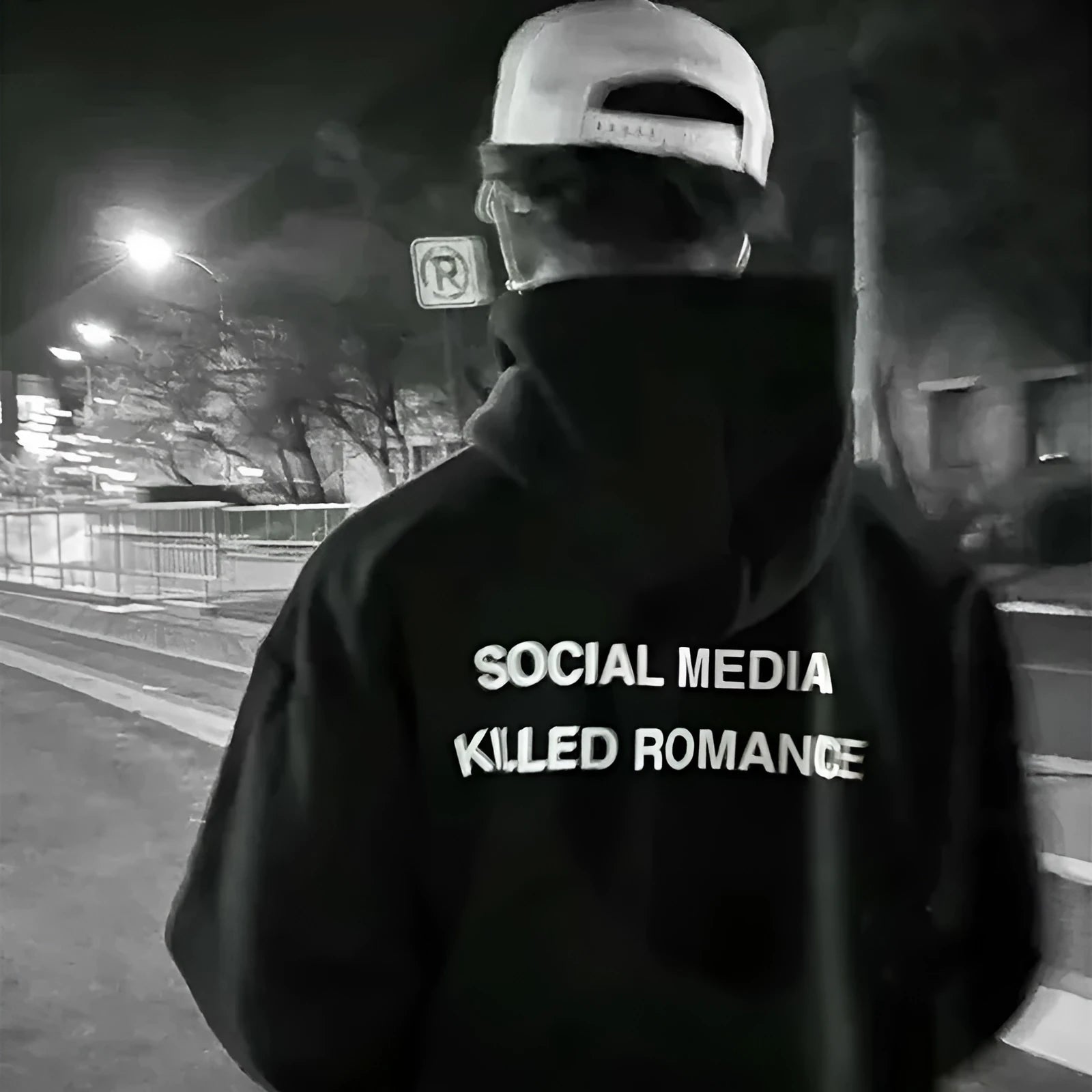 Man wearing a slim fit grey hoodie with a printed white spring letter pattern on the front.