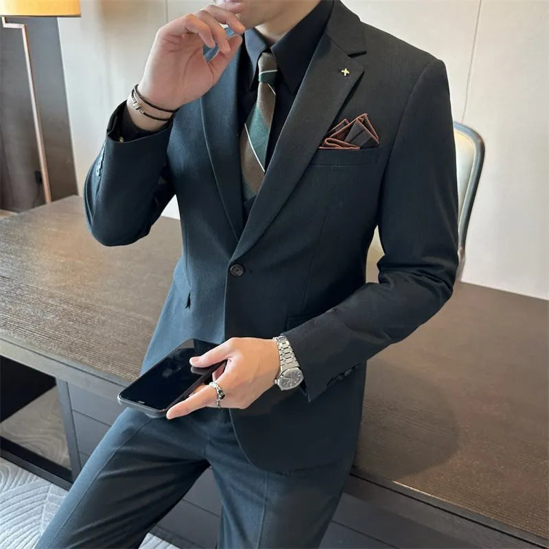 Men's slim fit business formal jacket and trousers in a dark green chemical fibre blend fabric.