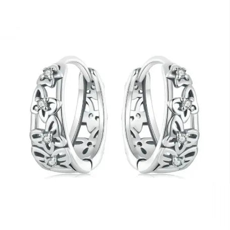 Sterling silver hollow butterfly earrings with zircon accents on white background