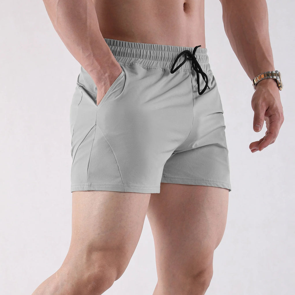 Men's thin grey polyester basketball shorts with an elastic waistband on a plain background