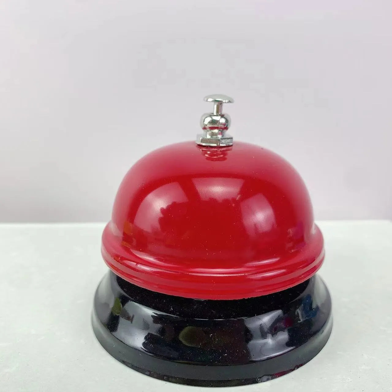 Handheld iron game bell in one of ten colours like red, blue, or green tea, for classroom or restaurant use.