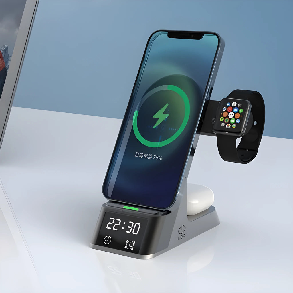 Black six-in-one wireless charging alarm clock station on a desk next to a phone and smartwatch.