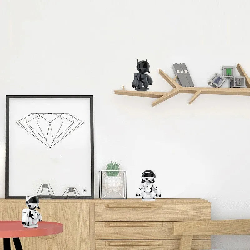 White or black wireless indoor security camera with a detachable base, shown on a shelf for home monitoring.