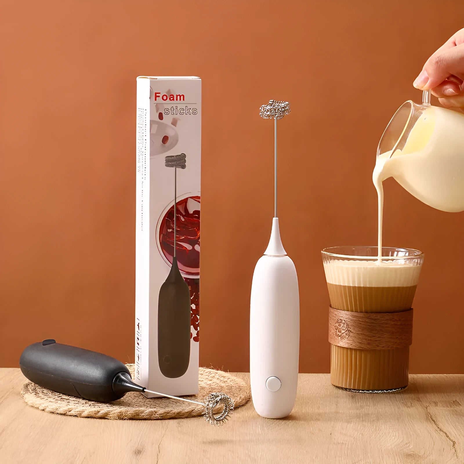 Black and white electric milk frother handheld blender for coffee drinks