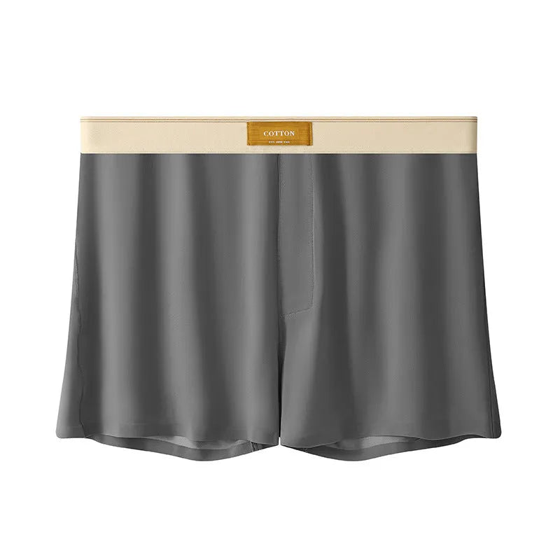 Pack of three men's solid colour loose fit ice silk underwear briefs on a grey background.