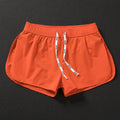 Men's loose beach surfing shorts in quick-dry polyester available in orange, green, and black