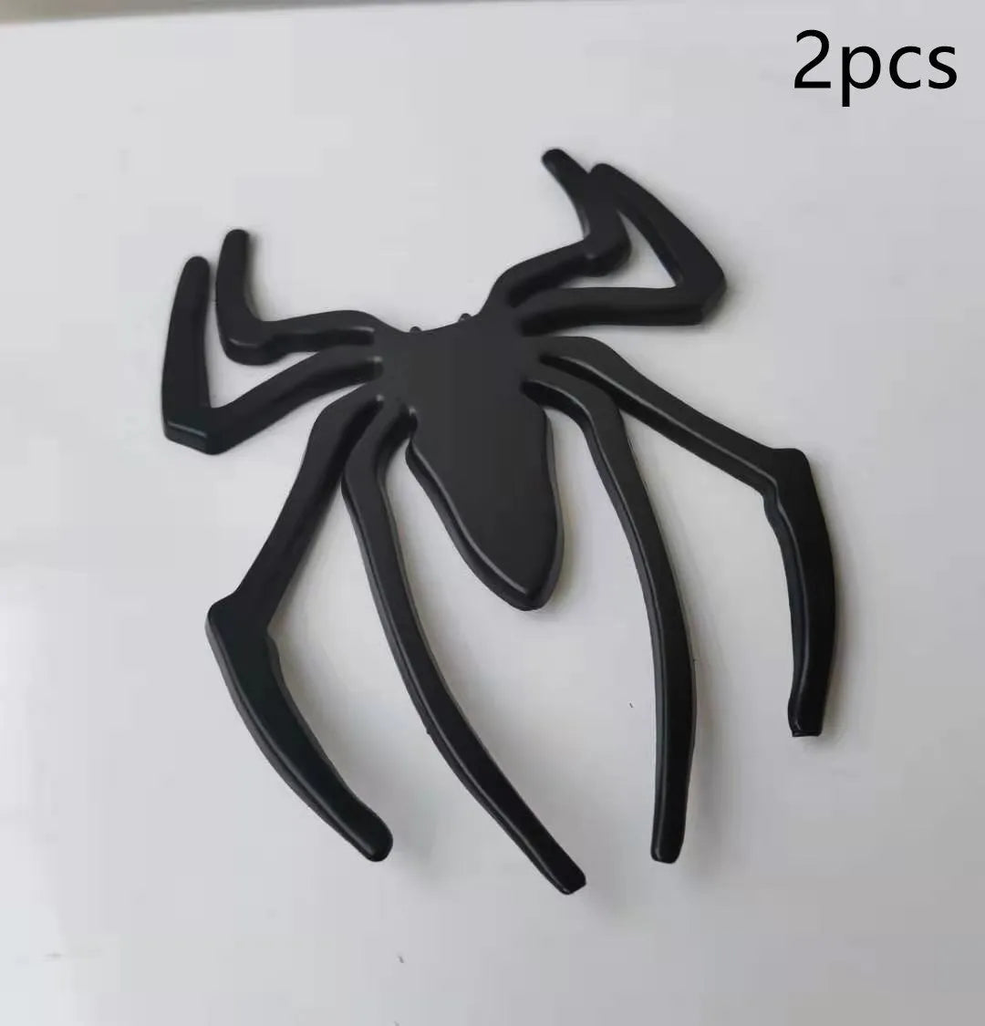 Three-dimensional metal spider bumper sticker in zinc alloy, shown in gold colour.