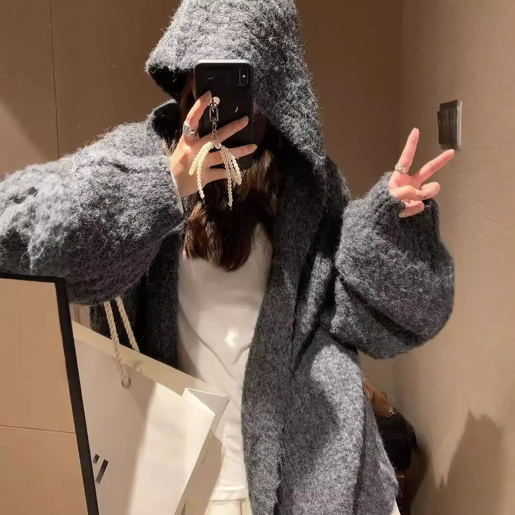 A woman's dark grey hooded cardigan with long sleeves, shown open in a loose fit.
