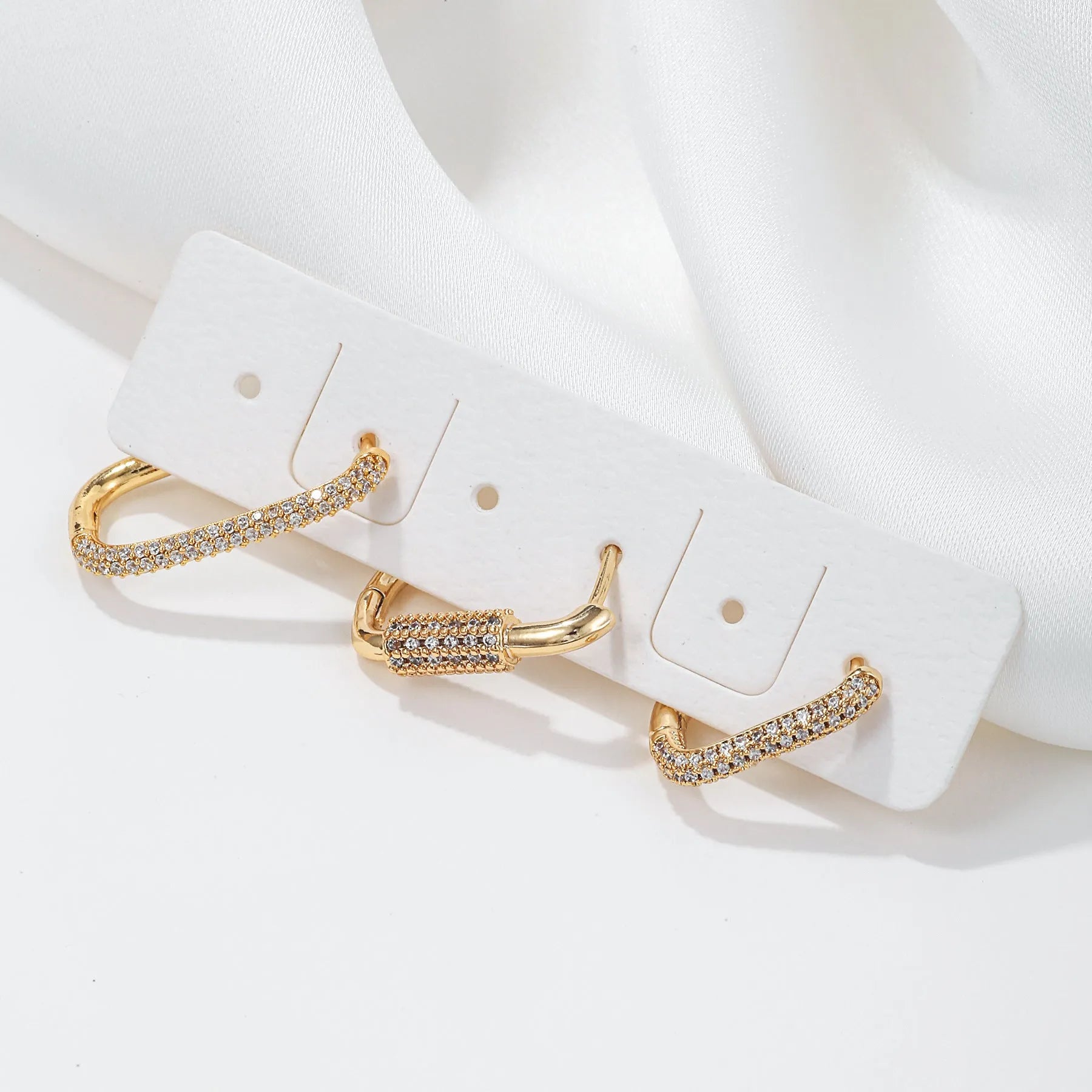 Three geometric zircon ear clips with square design in gold and white colour options