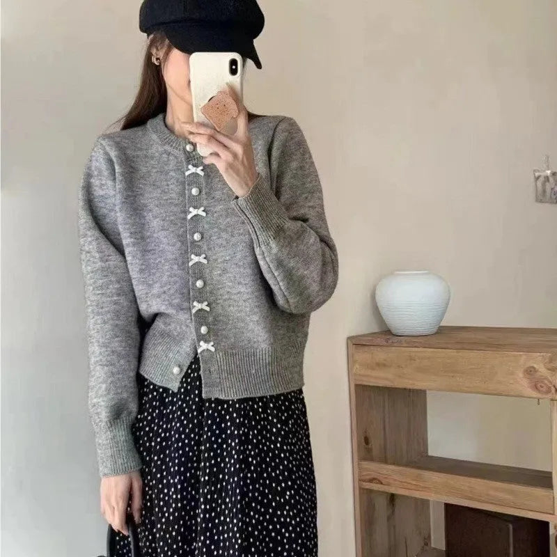 Women's acrylic cashmere cardigan sweater with bow and pearl button detail in nine colour options