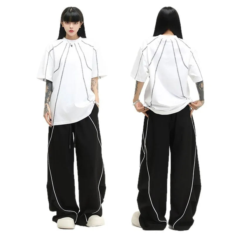 Black pleated hip hop trousers with wide-leg design and stripe pattern