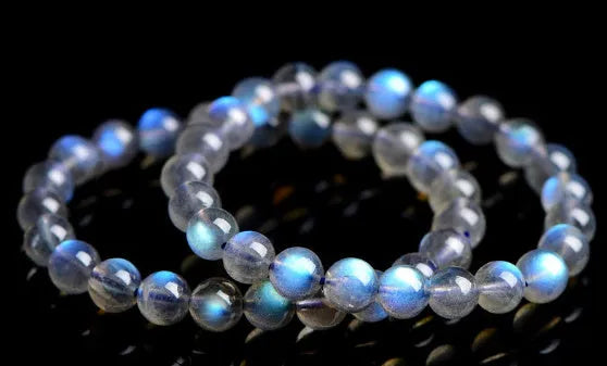 Natural cream body crystal bracelet with spherical beads on a wrist, showing minimalist unisex design.