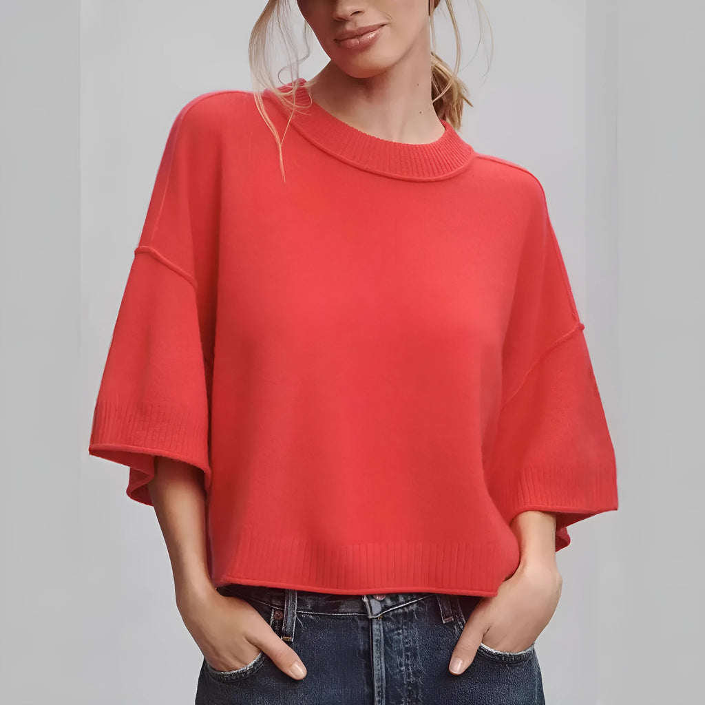 Red women's crop top t-shirt with regular sleeves on a hanger.