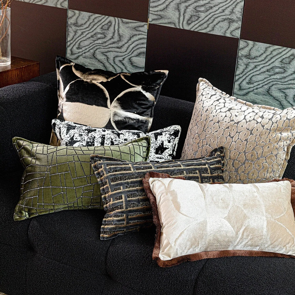 Black and gold abstract patterned flannel cushion on a sofa, showing removable cover.
