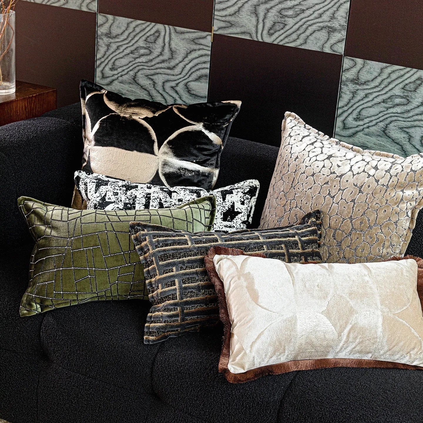 Black and gold abstract patterned flannel cushion on a sofa, showing removable cover.