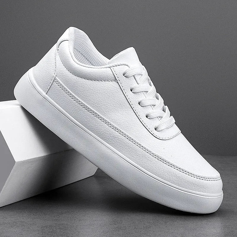 Women's white leather flat casual shoes with front lace-up closure.