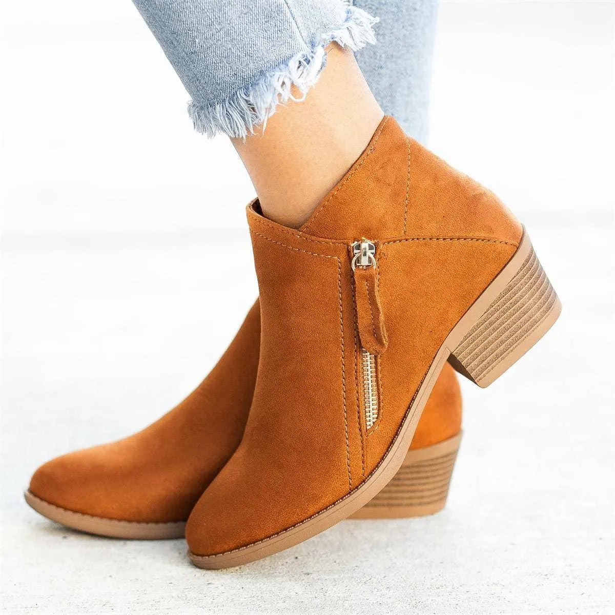 Women's suede ankle boot with side zip, chunky heel, in beige, black, blue, or orange.