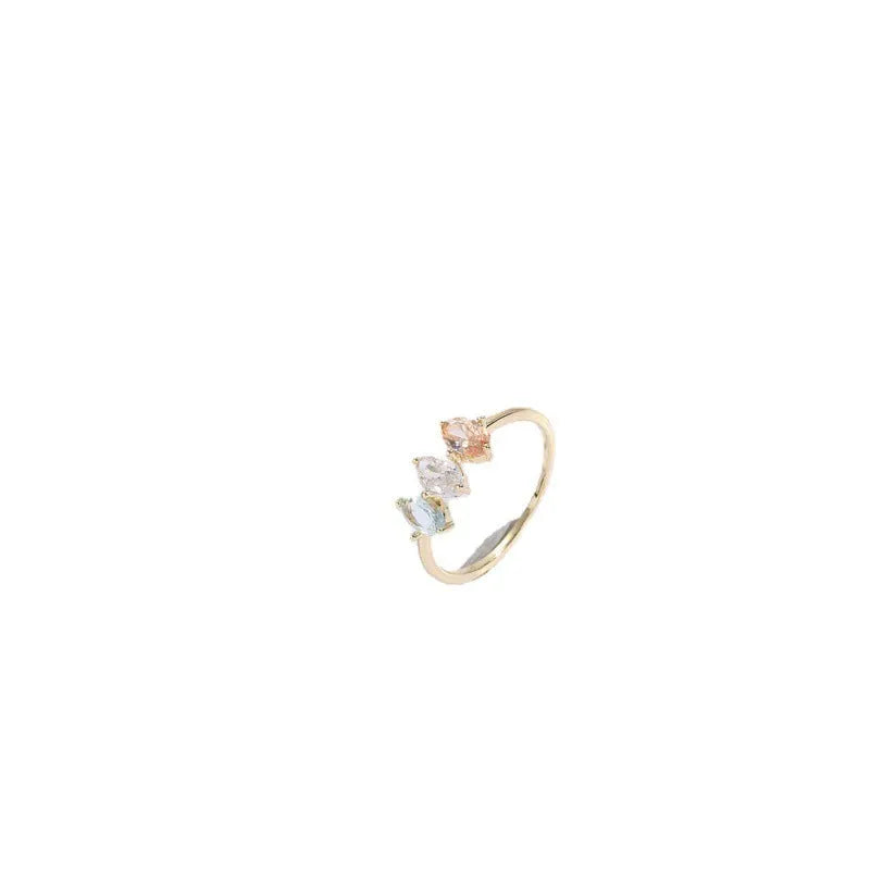 Gold geometric women's ring with horse eye design and three coloured zircon stones on a triangular band.