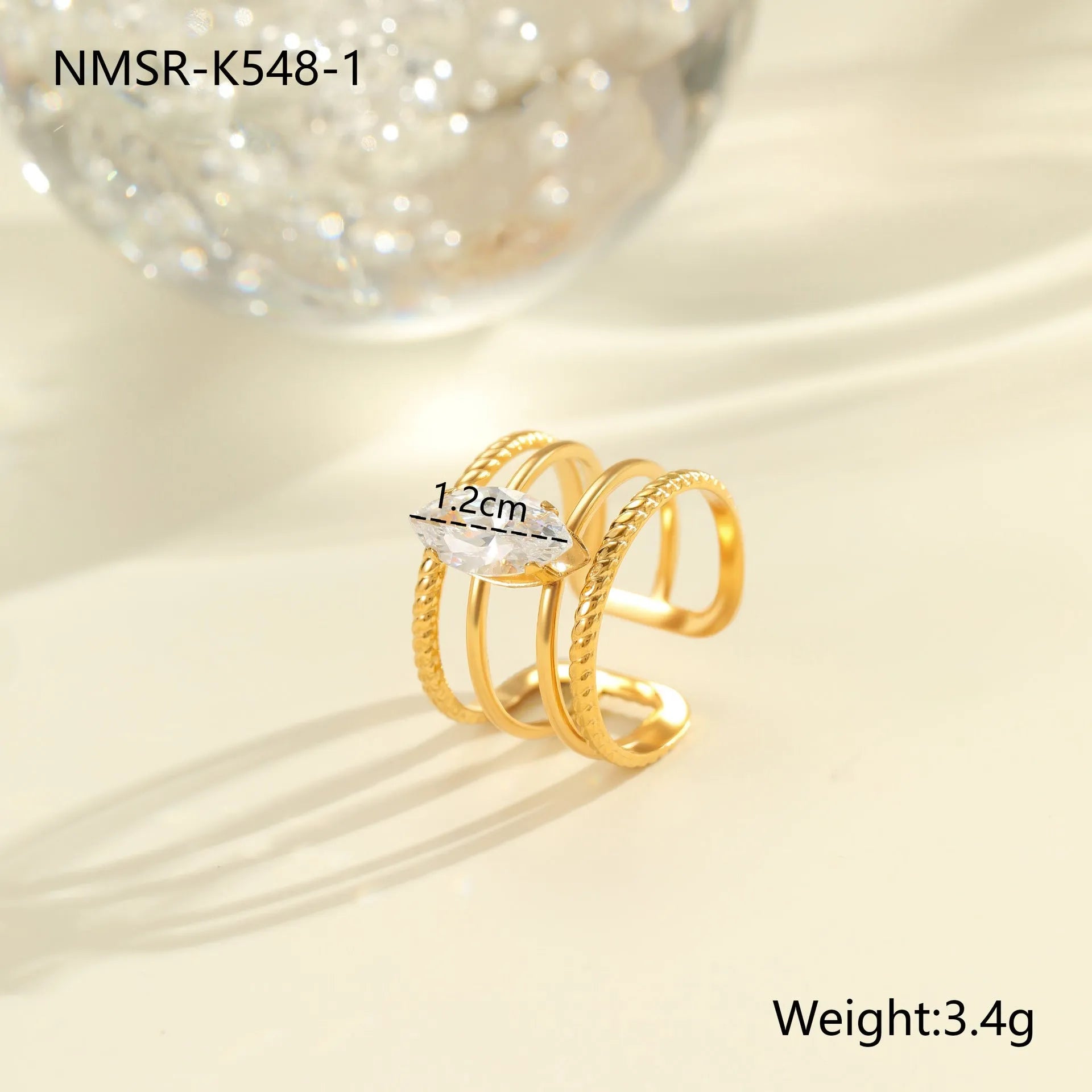 Gold inlaid zircon geometric heart and drop shape stainless steel ring on white background.