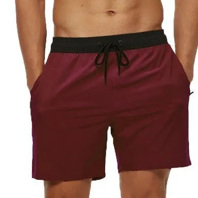 Men's blue running shorts with stitching waistband, zipper pocket, and drawstring for fitness activities